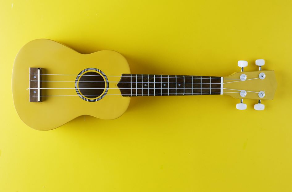 Image shows a yellow ukulele. Click the image to reserve a ukulele